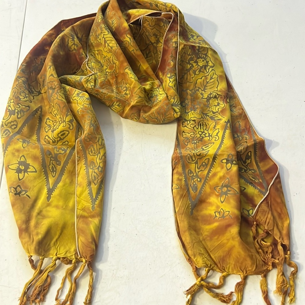 Fall colors with leaf design on the scarf made by Golden Road Imports
